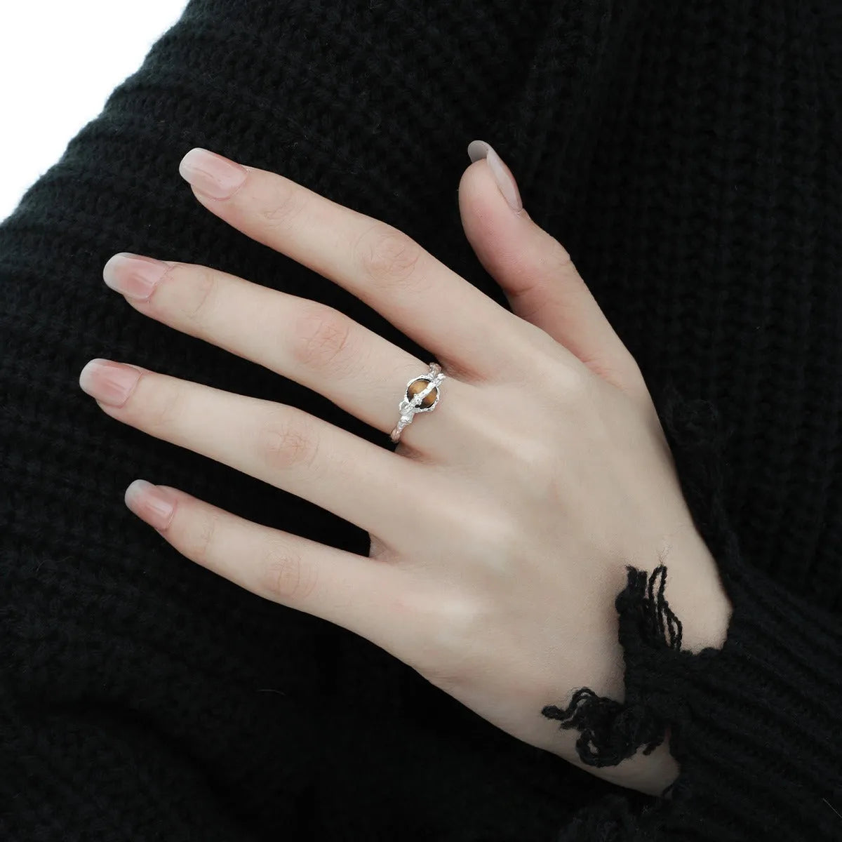 Saturn-themed adjustable open ring in electroplated white gold colour with tigereye gemstone detail