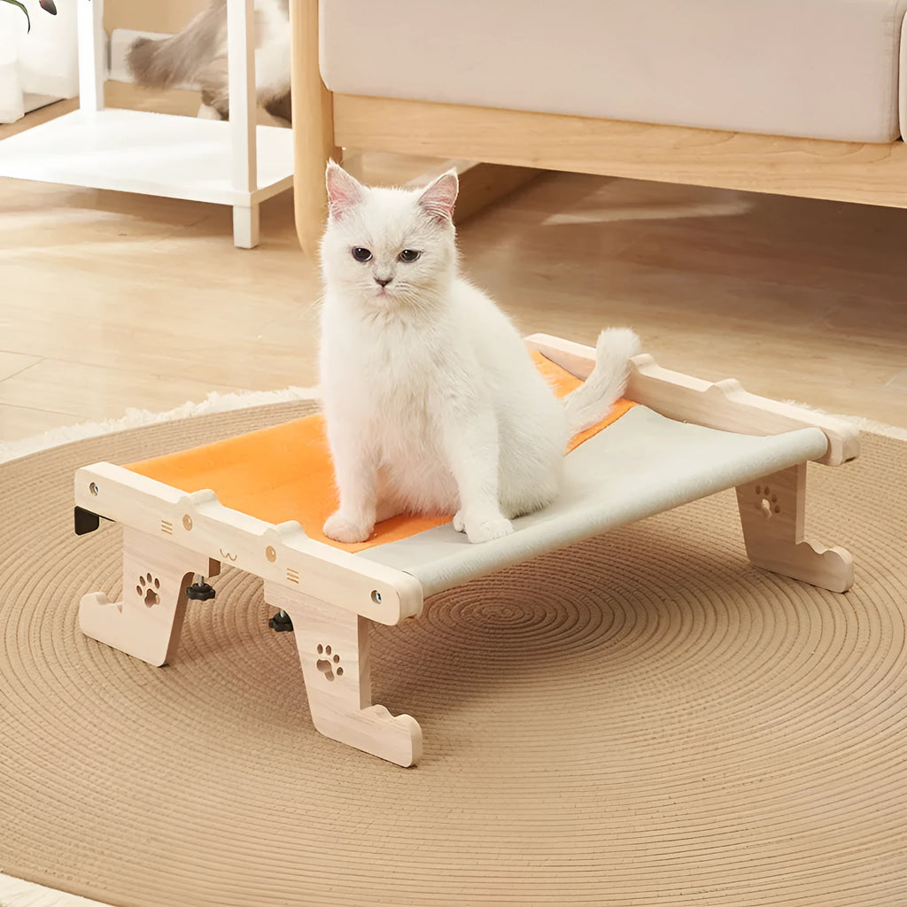 Wooden frame cat hanging bed with fabric hammock mounted by a window