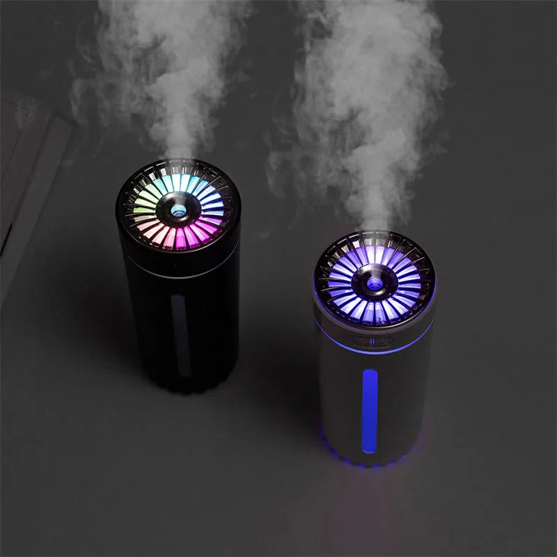 Black portable wireless ultrasonic humidifier with colourful LED lights on a car cup holder.