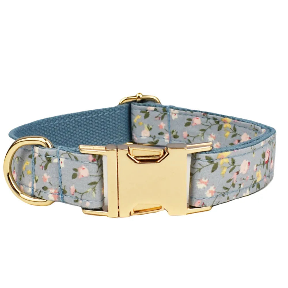 Blue floral patterned fabric bow attached to a decorative dog collar for pets