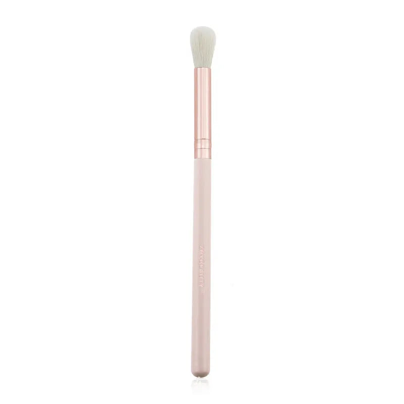 26 pink makeup brushes with wooden handles laid out next to a matching storage bag.