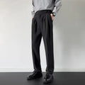 Men's straight loose fit suit trousers in apricot colour, laid flat.