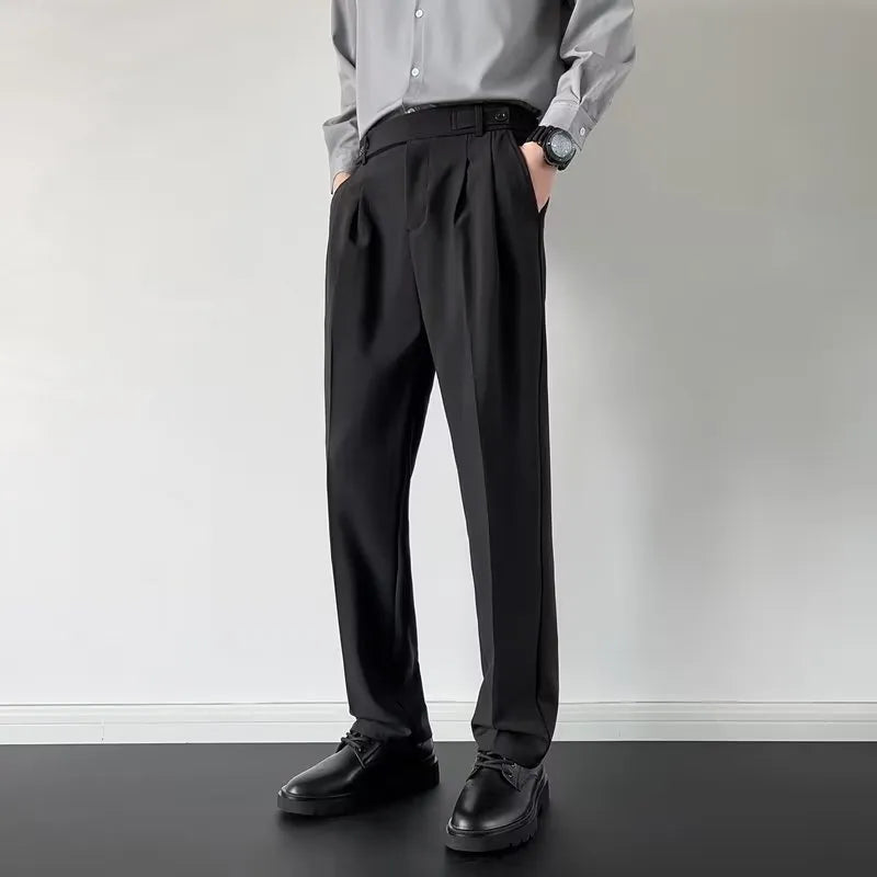 Men's straight loose fit suit trousers in apricot colour, laid flat.