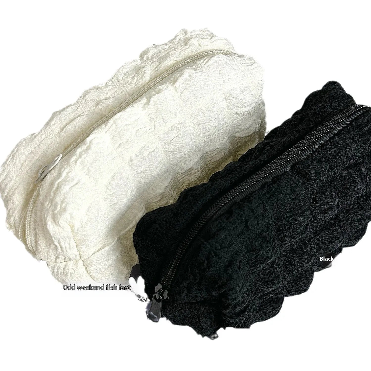 Beige and black fabric pencil cases with cream puff textured design and zipper closure
