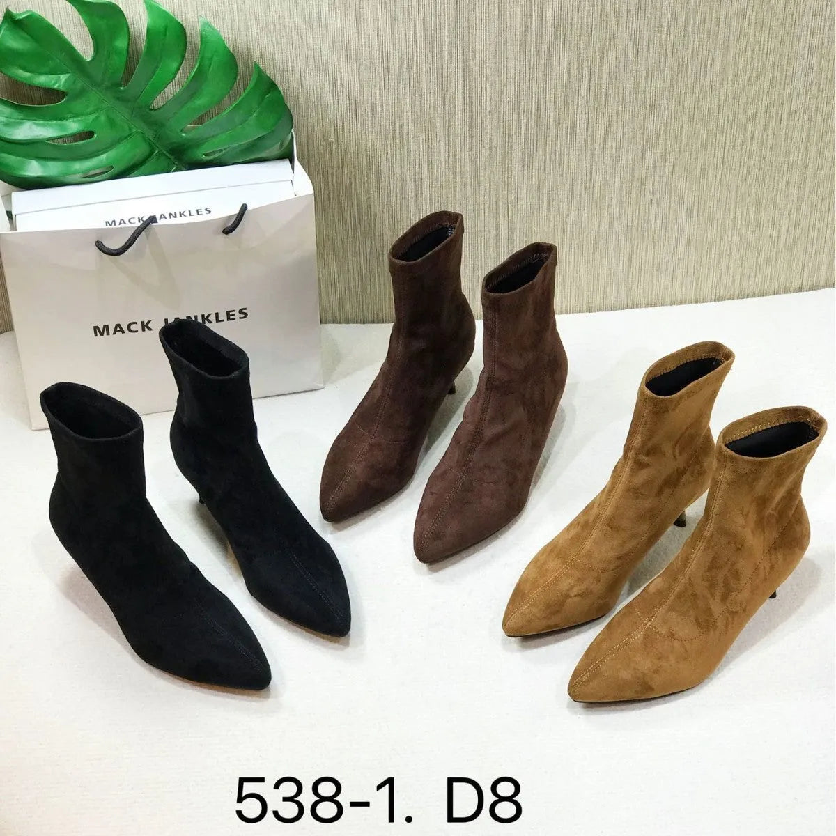 Black pointed toe women's ankle boots with a stiletto heel on a plain background.