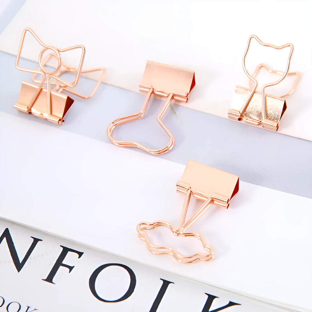 Gold-coloured metal office clip in decorative bow shape design
