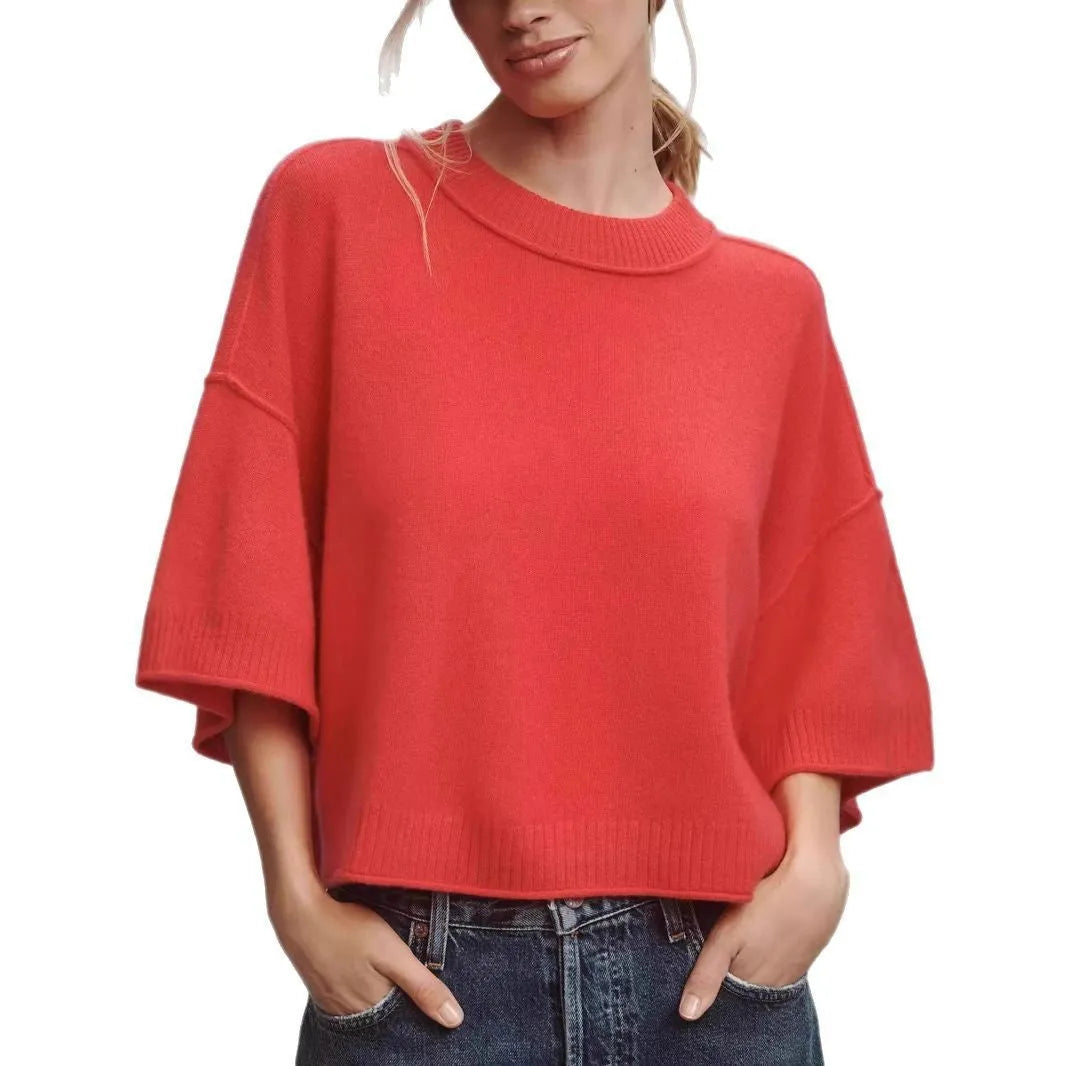 Red cropped t-shirt on a hanger, showing midriff length and regular sleeves.