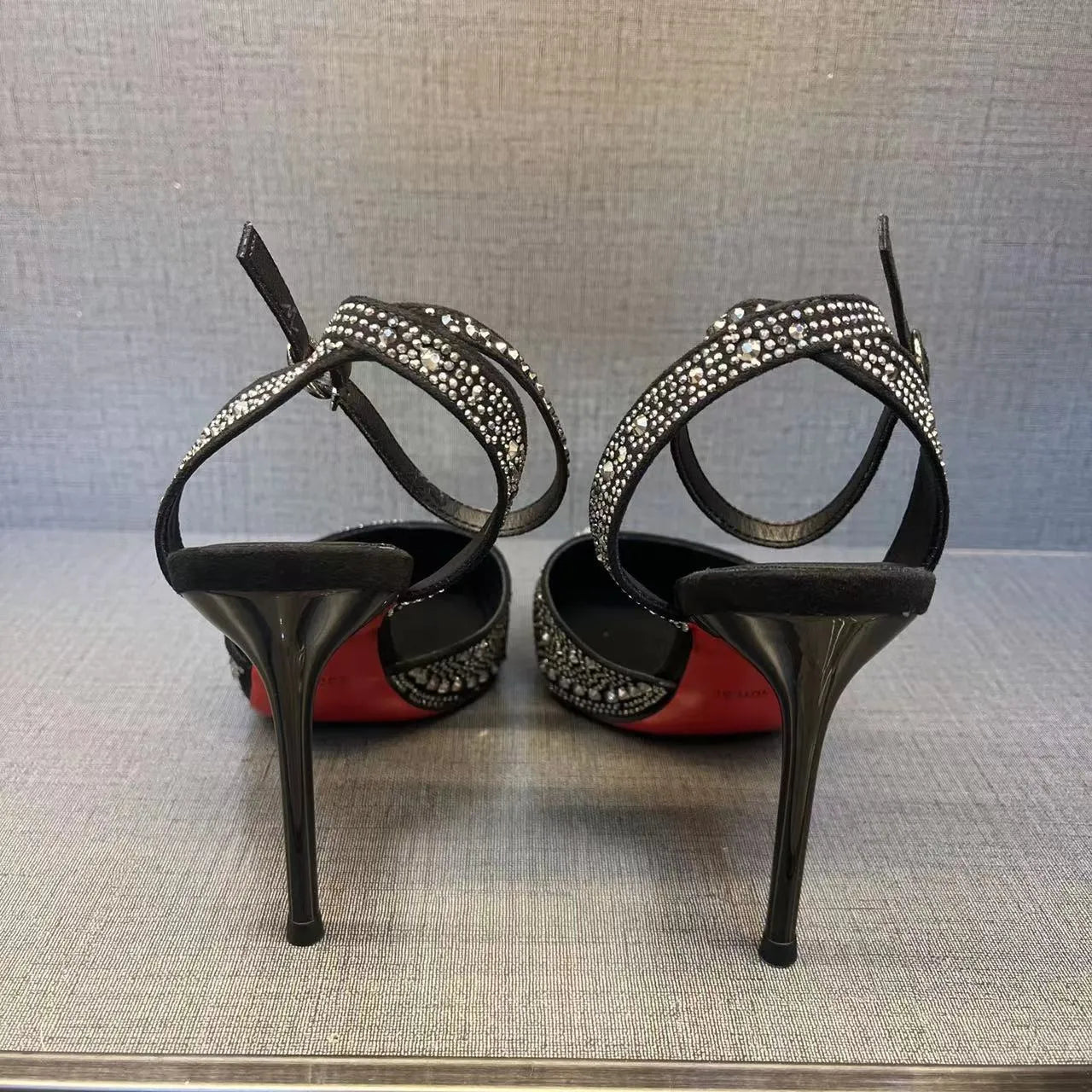 Women's silver and black hollow high heels with red sole and pointed stiletto heel
