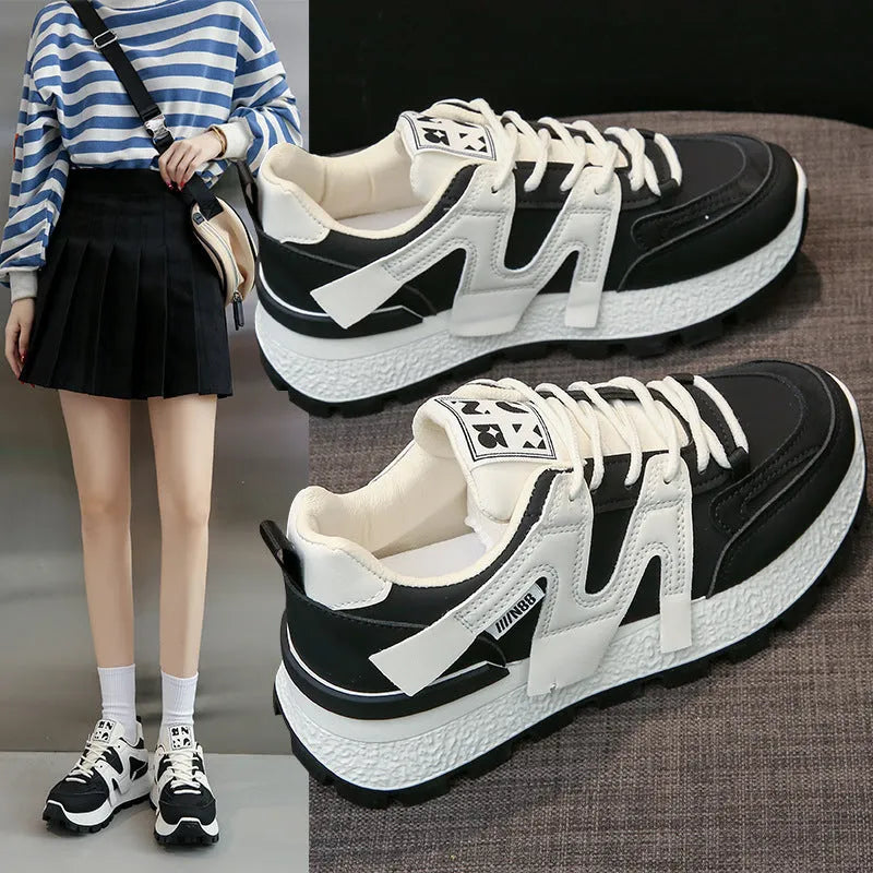 A pair of solid-colour low-top sneakers with a round toe and front lace-up, shown in white or black.