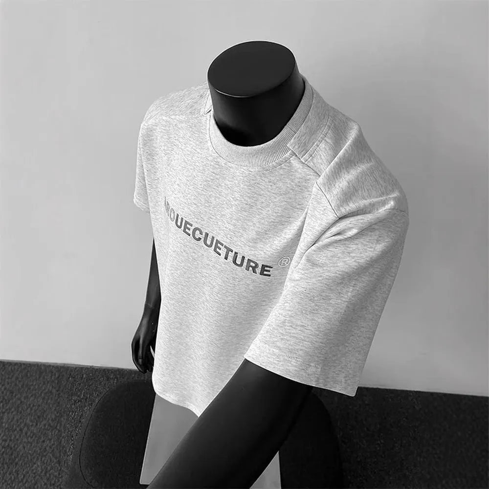 Man wearing a loose fit black short sleeve cotton T-shirt with a white graphic letter print.