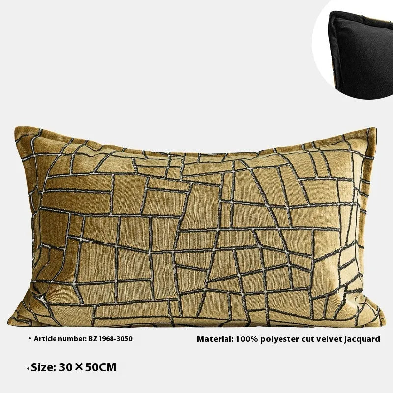 Gold geometric pattern decorative cushion cover on a grey sofa