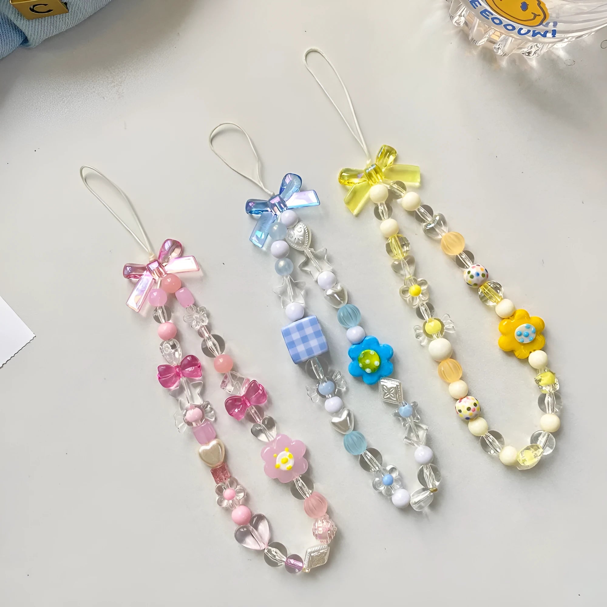 Yellow floral bead mobile phone lanyard with plastic and resin decoration on rope strap
