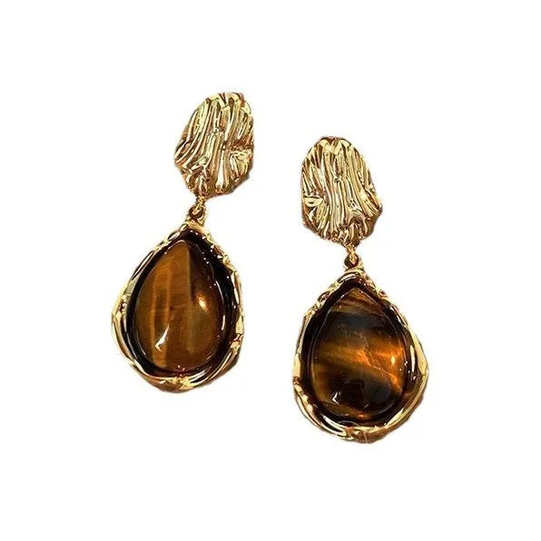 Three pairs of geometric women's earrings with tassel details in irregular, wafer, and water drop styles.