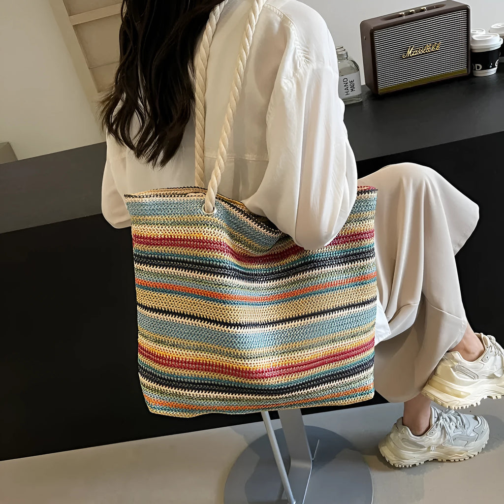 Blue straw woven nylon shoulder bag with large capacity and polyester lining.