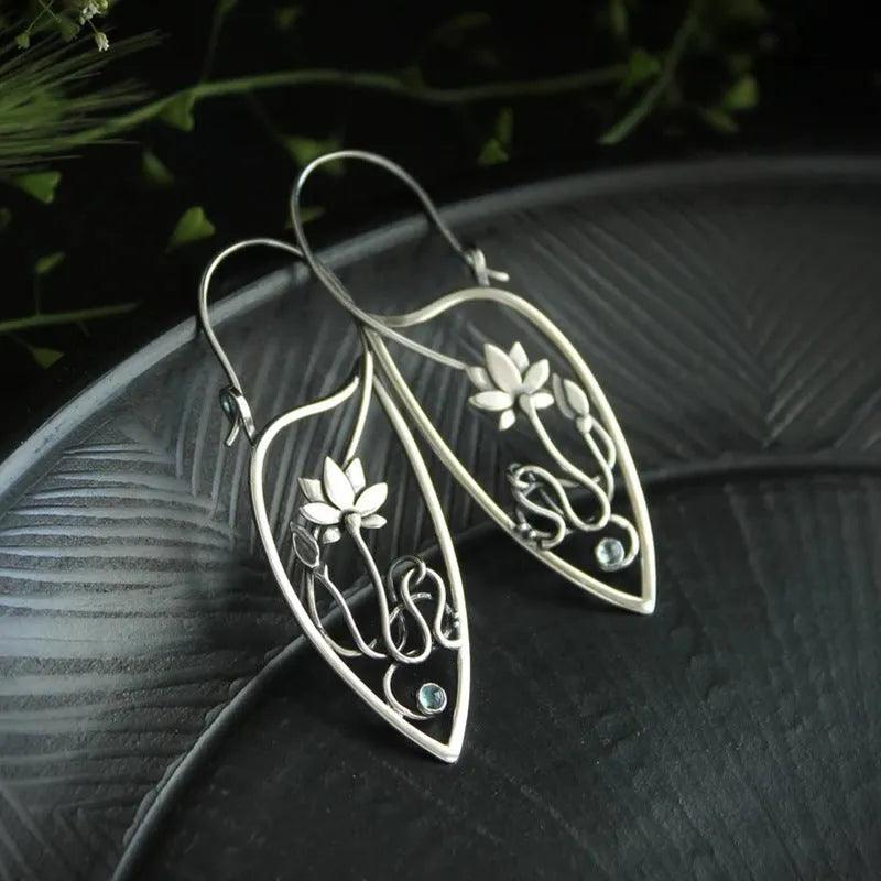 Silver rhinestone earrings with lotus vine design featuring geometric floral shapes and round crystal elements