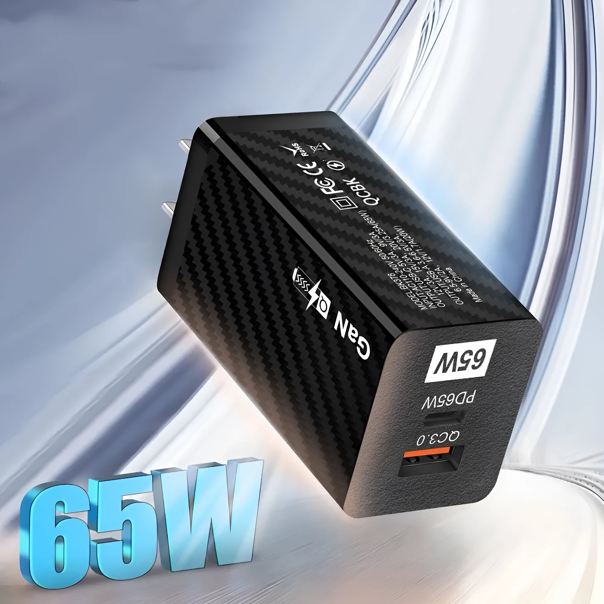 65W GaN fast charger showing compact size next to laptop with USB-C cable