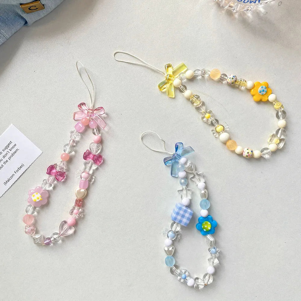 Yellow floral bead mobile phone lanyard with plastic and resin decoration on rope strap