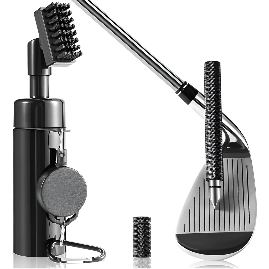 Black plastic golf club groove cleaning tool on a grassy surface with a golf ball nearby