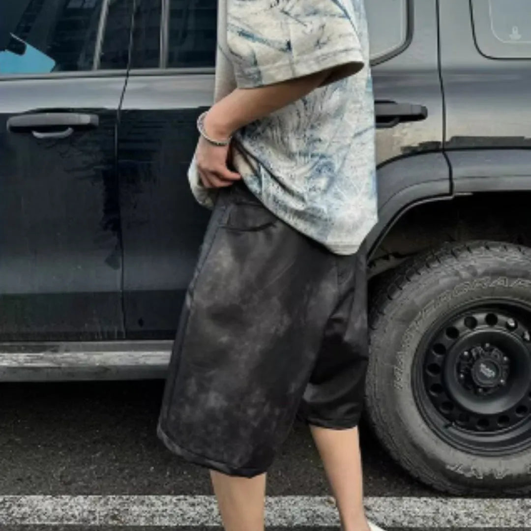 Man modelling a loose-fit, short-sleeved T-shirt with a blue and white tie-dye print pattern.