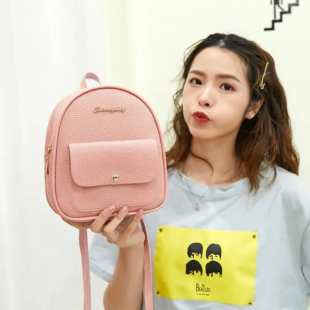Small PU leather shoulder backpack in black colour showing zipper closure and compact dimensions