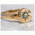 Gold star-shaped ring with asterism zircon on adjustable band.