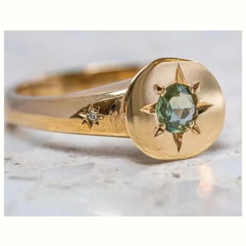 Gold star-shaped ring with asterism zircon on adjustable band.