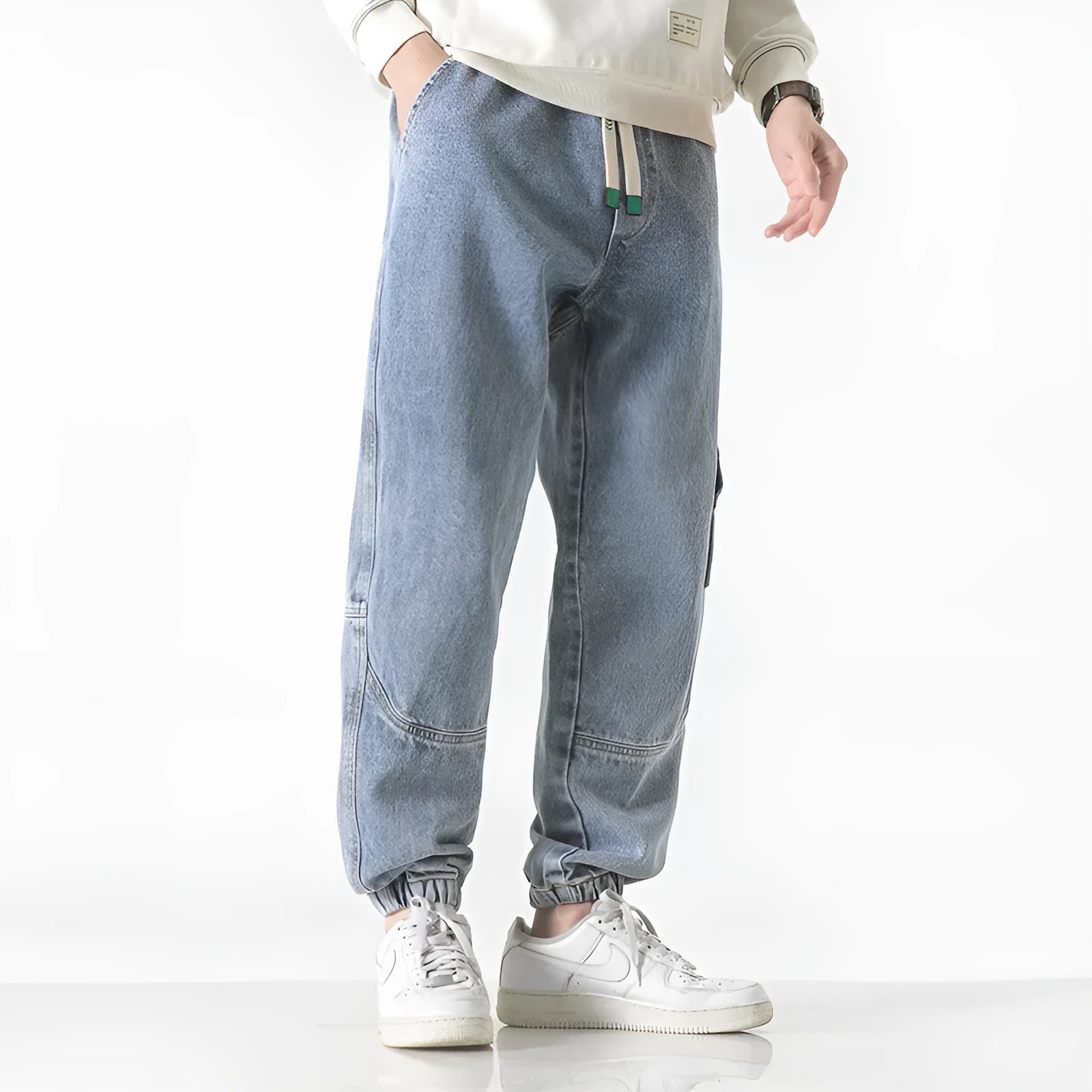 Men's loose-fit tapered trousers in cotton fabric showing mid waist design and tapered leg cut