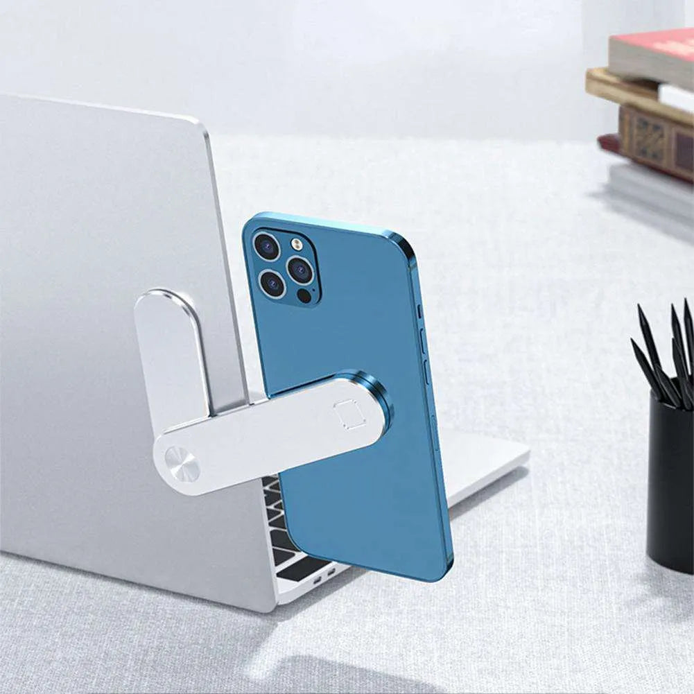 Black aluminium laptop phone holder with magnetic mount attached to a monitor showing a smartphone in place