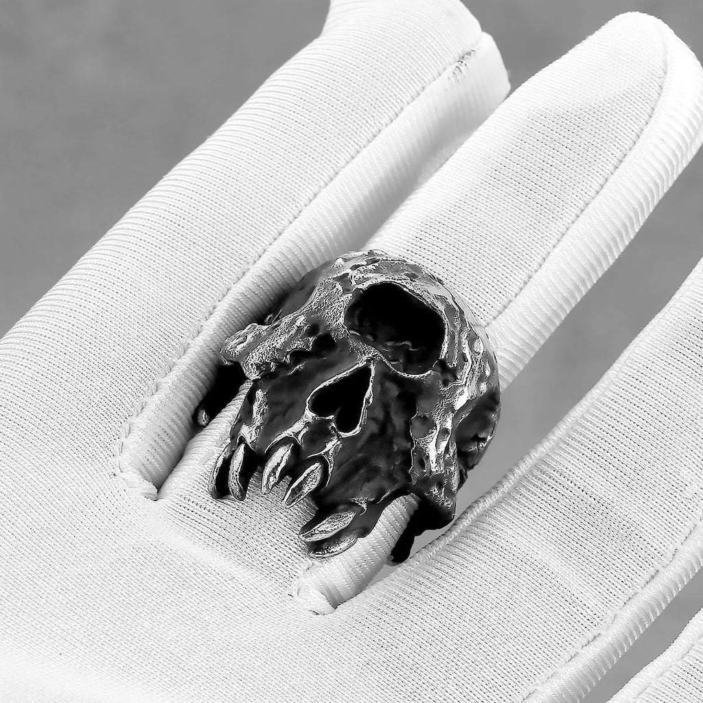 Alloy skull ring with one-eyed design and electroplated metallic finish shown on hand