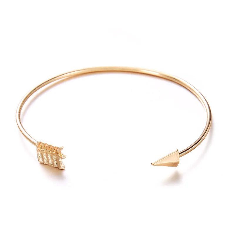 Women's vintage cuff bracelet with arrow and knotted design in gold electroplated alloy