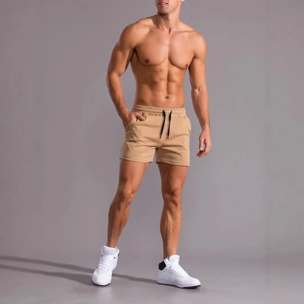 Men's black, khaki, and light brown drawstring casual shorts laid flat, showing loose fit and elasticated waistband.