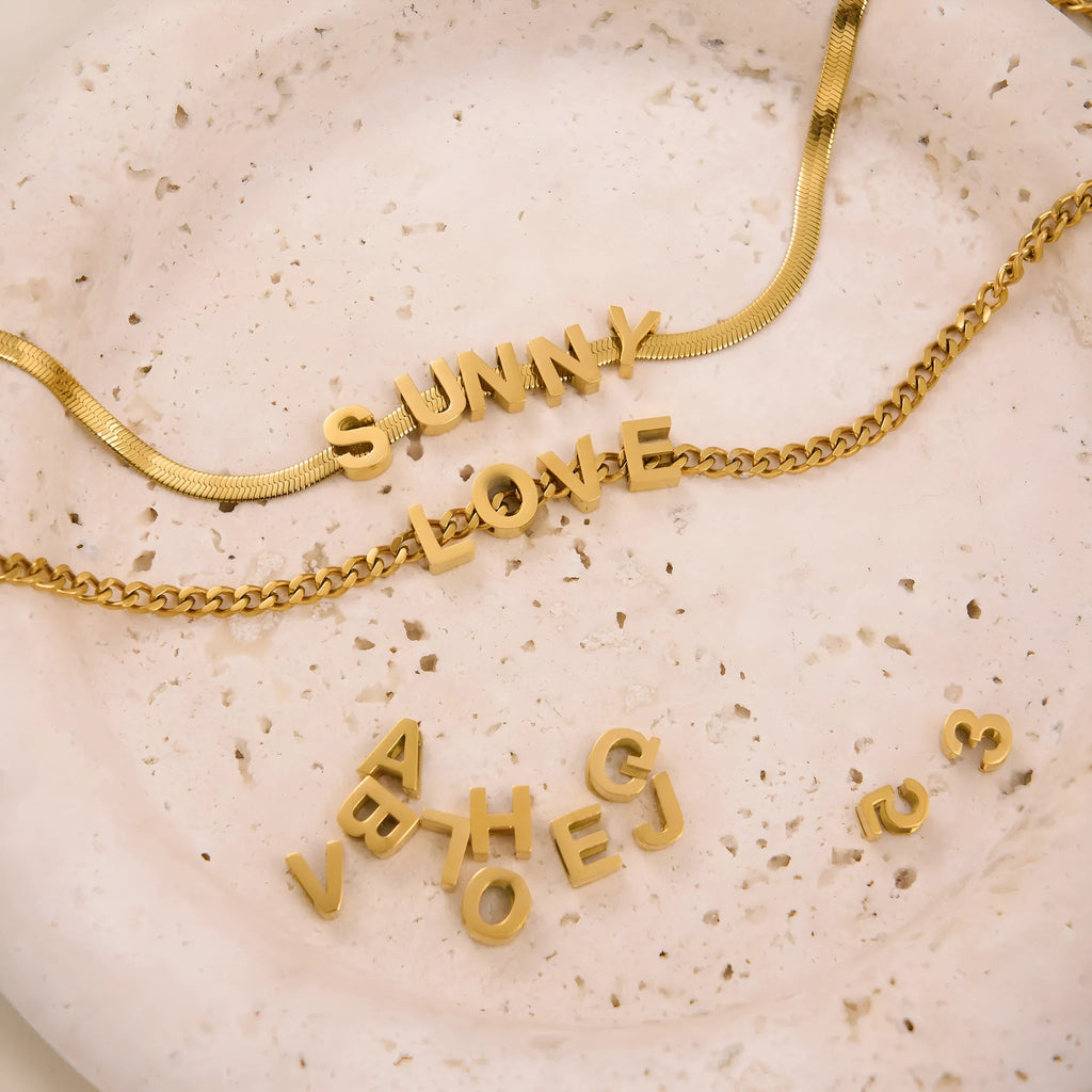 Gold titanium steel necklace with the letter A pendant on a 40.5cm blade-style chain.