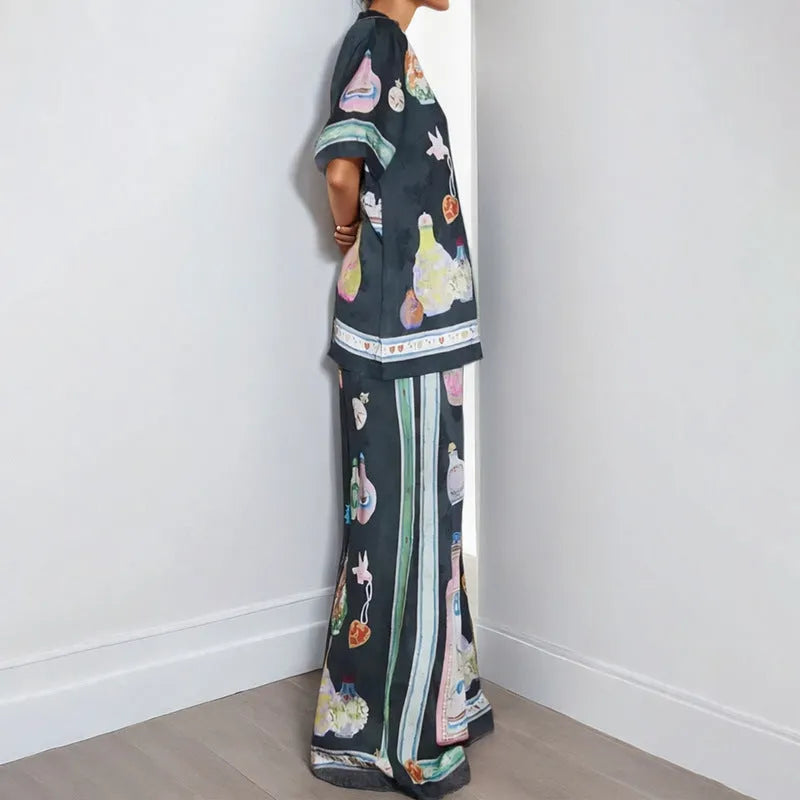 Black women's cardigan and pants set with cartoon animation print.