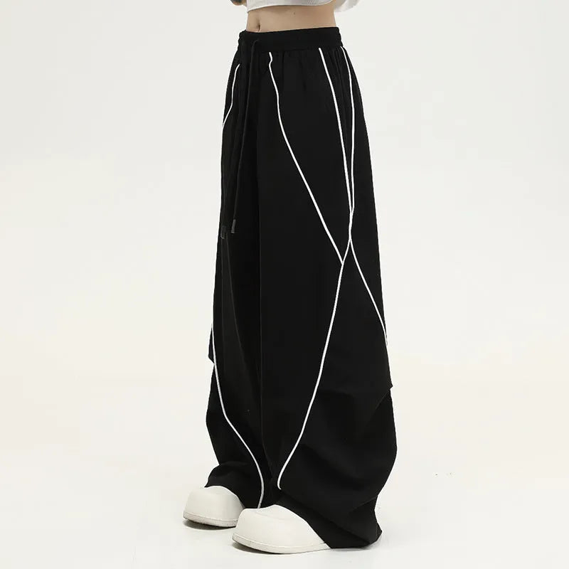 Black pleated wide-leg hip hop sports pants with stripe pattern laid flat