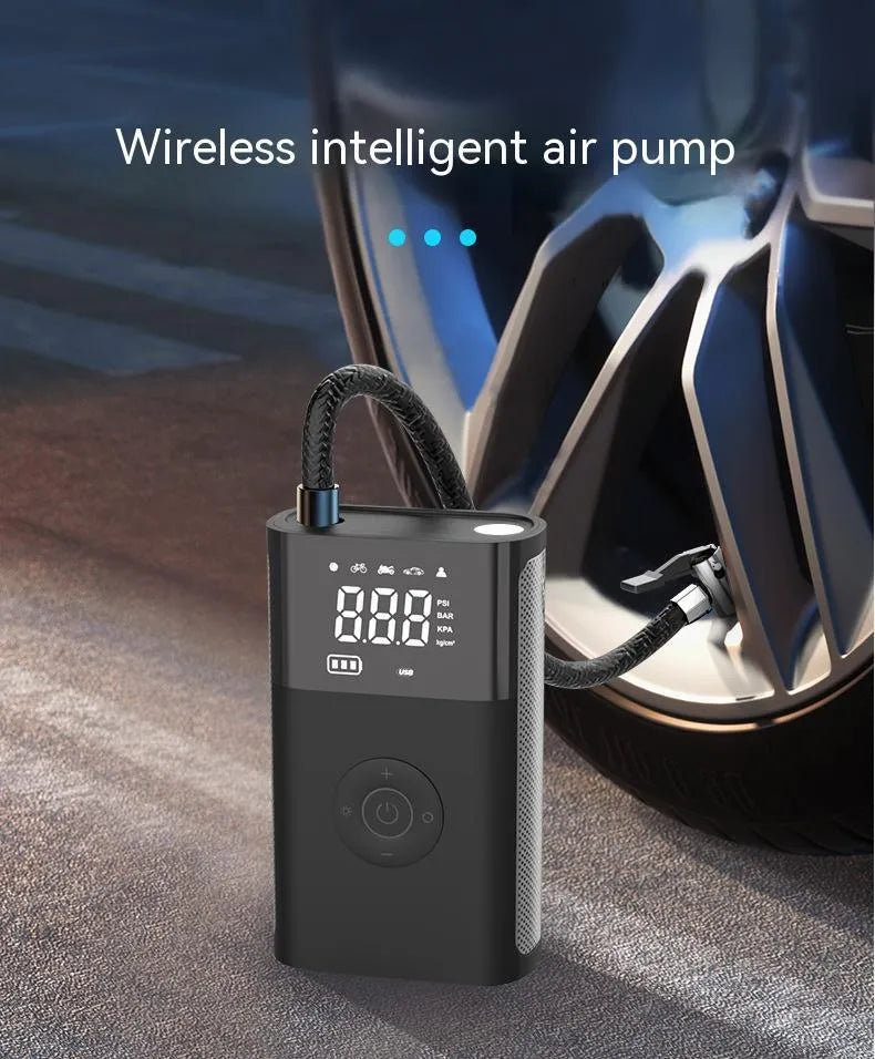 T2191-2 handheld wireless digital display air pump with LED light and multiple nozzle attachments on a table.
