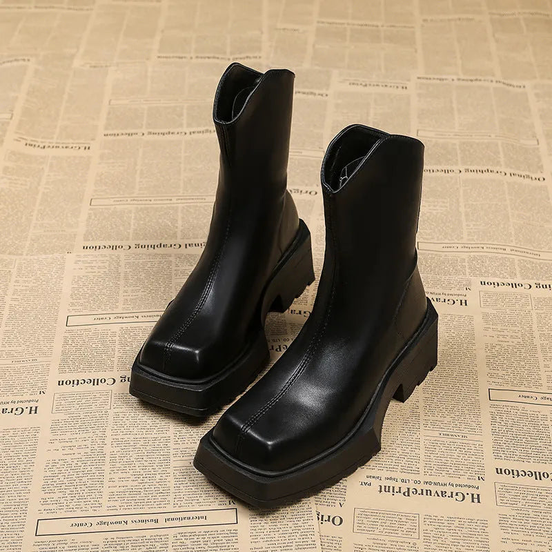 Women's black square-toe platform Martin boots with a block heel and rear zip on a white background