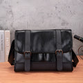 Black polyurethane commuter backpack with contrast stitching and anti-theft features