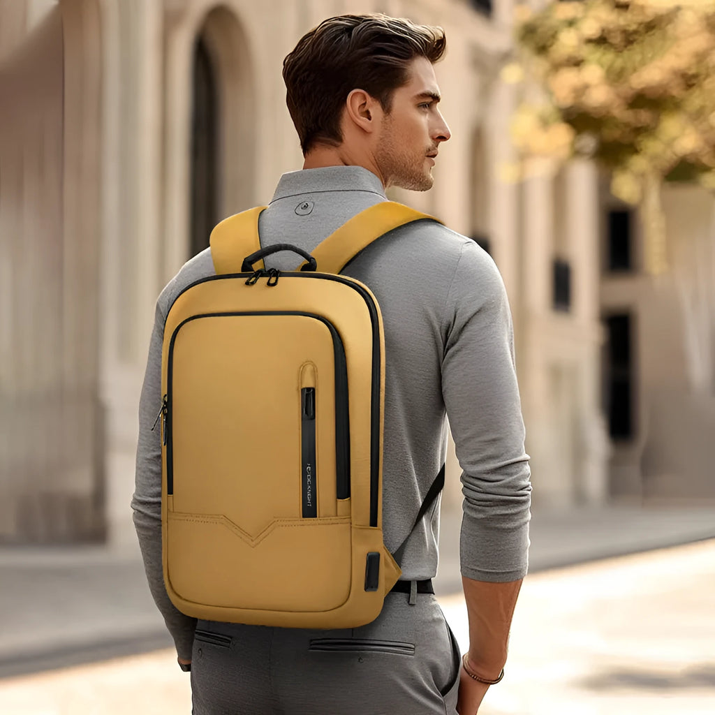 Lightweight black polyester laptop backpack with USB charging port shown next to a 14-inch laptop.
