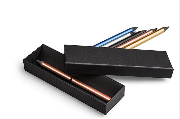Silver inkless metal pen with alloy tip, spare nib, and presentation box on a desk.