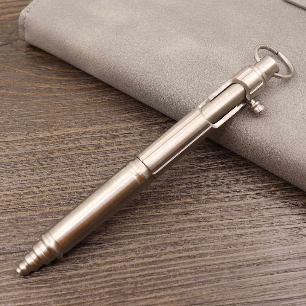A retro-style brass tactical pen with a bolt-type metal design and press mechanism.