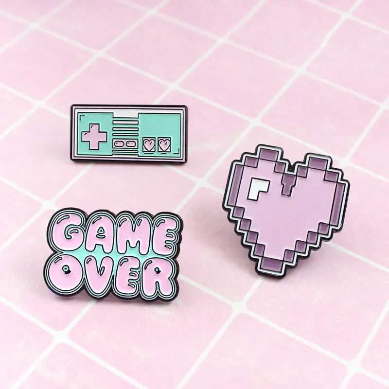 Stereo game console badge made from alloy, shown in one of three colour options with independent OPP packaging.