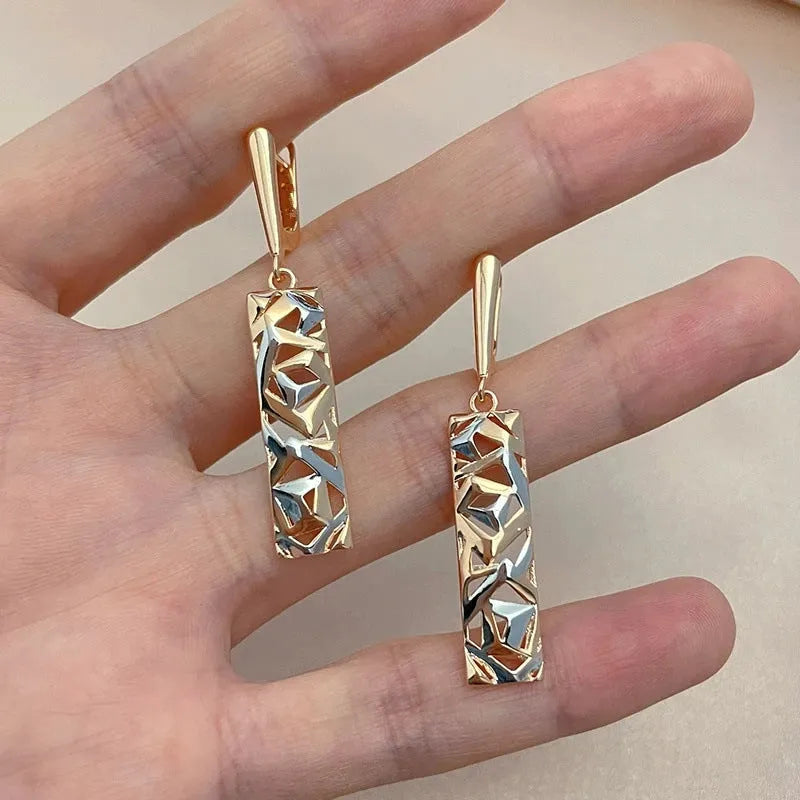 A pair of geometric hollow two-tone stud earrings with a rectangular shape and electroplated alloy finish.