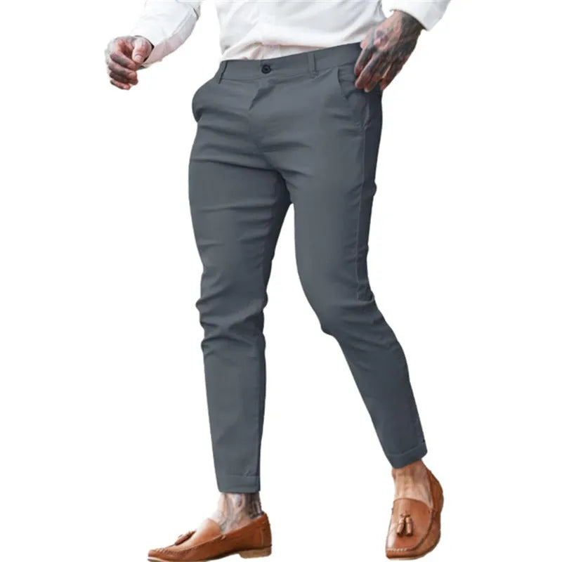 Men's slim fit stretch cotton twill pencil trousers on a hanger, shown in apricot colour.