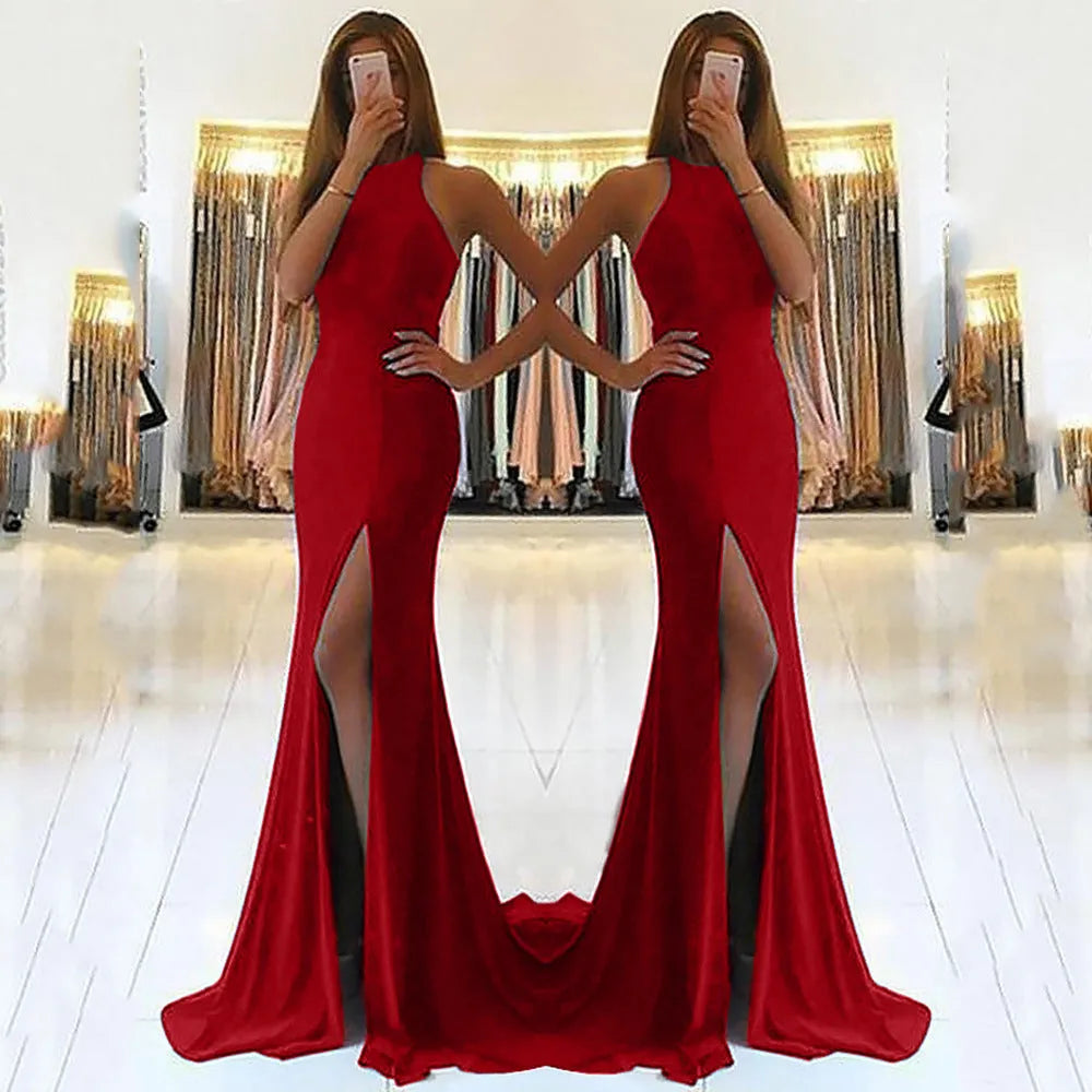 Long red knitted evening dress with hollow design detail on the skirt and a hanging neckline.