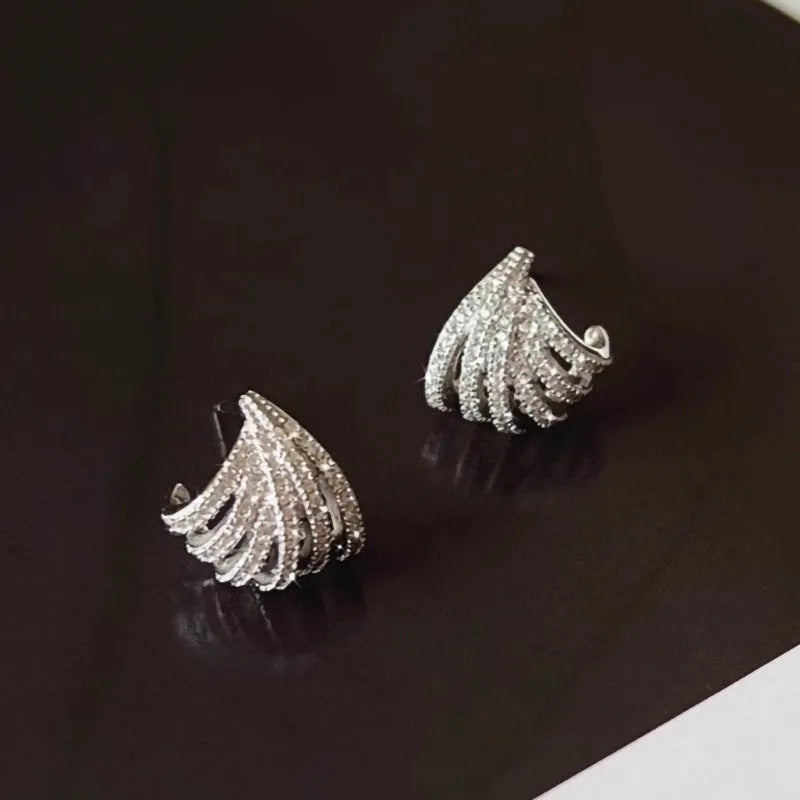 Geometric zircon earrings with platinum electroplated finish and line design detailing