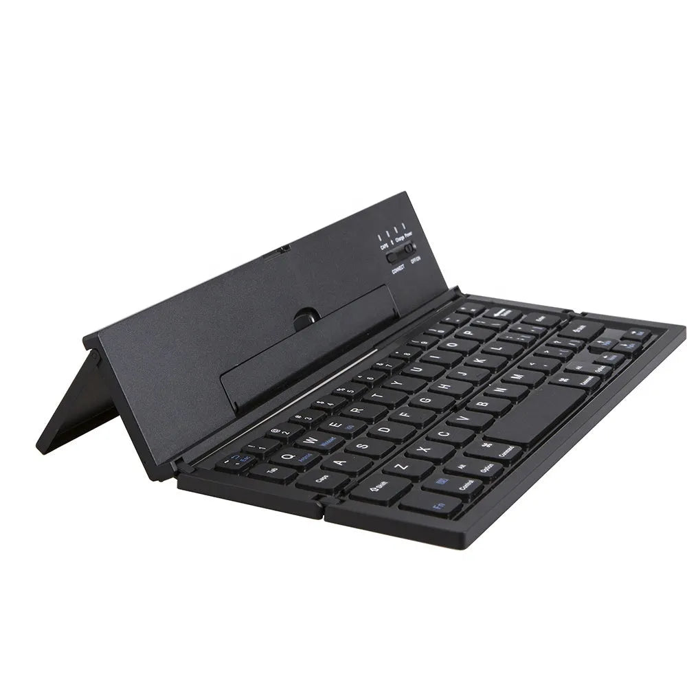 Black folding Bluetooth keyboard with aluminium bottom next to tablet
