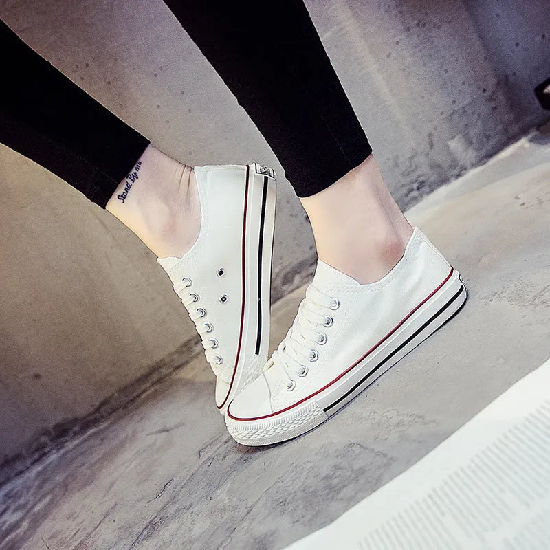 Women's solid colour canvas casual flat shoes on a plain background.