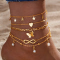 Four alloy anklets with butterfly, pearl and heart charms arranged as a layered jewellery set