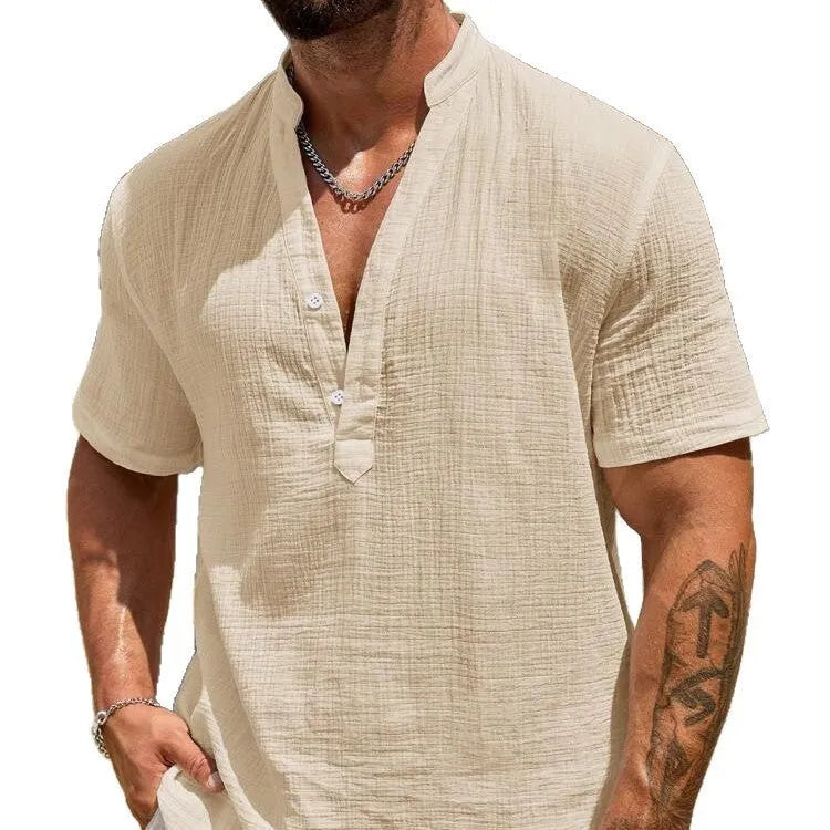 Man wearing a solid colour short sleeve casual shirt with a stand collar.
