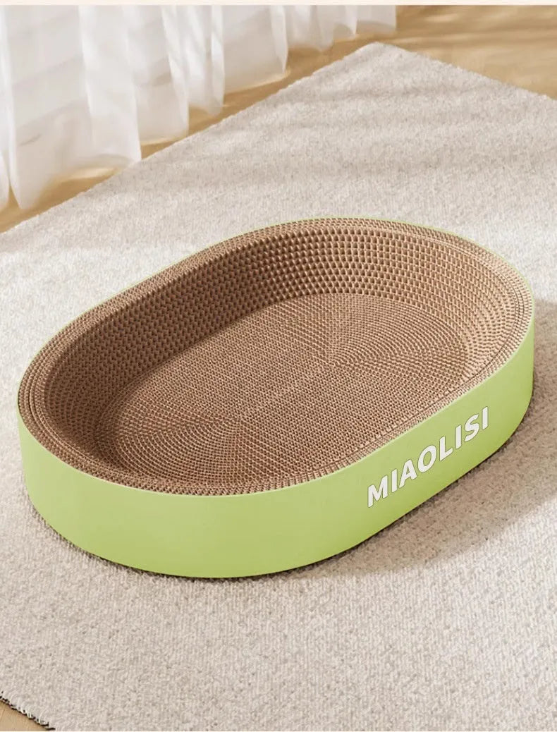 Green oval corrugated paper cat scratch board measuring 55cm across, functioning as both scratching surface and cat nest